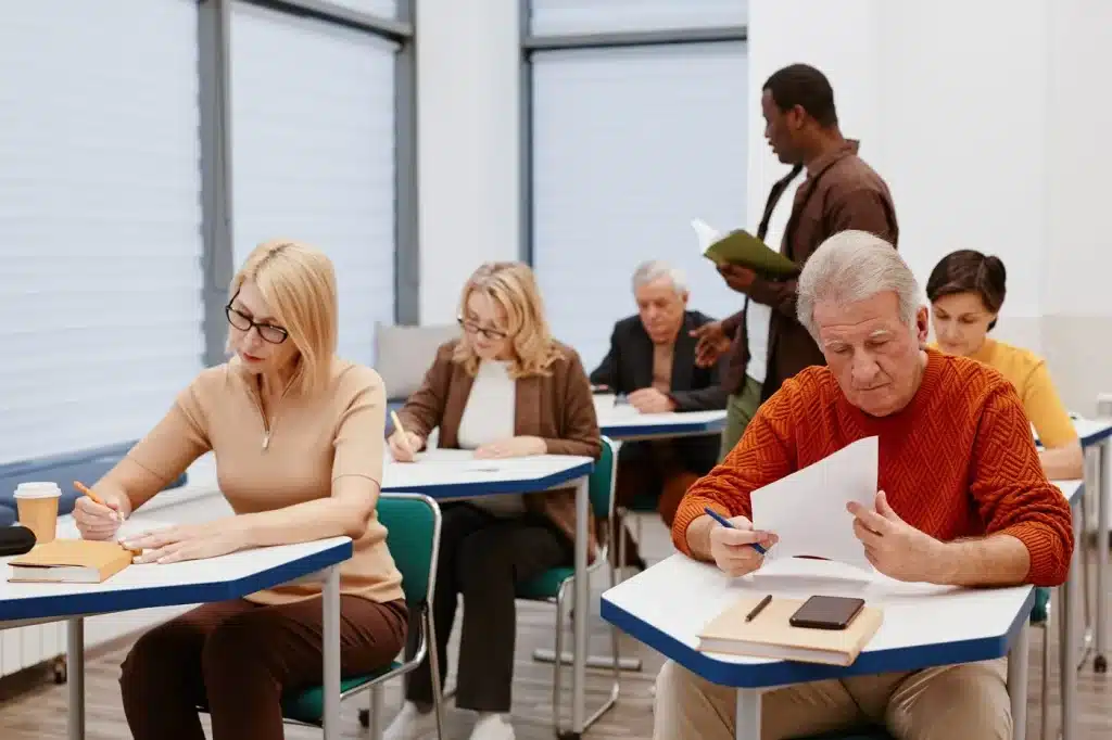 Instructor with adult students taking notes in a concealed carry class