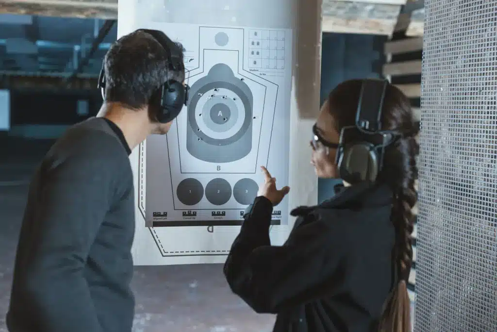 Instructor reviewing a paper target with a student on the range